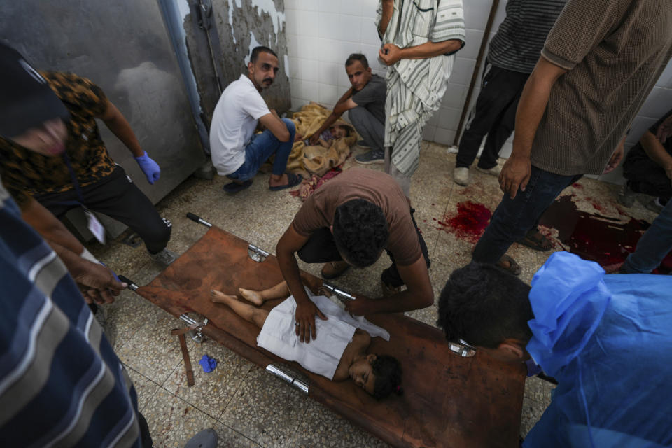 Palestinians mourn their relatives killed in the Israeli bombardment of the Gaza Strip in a hospital in Deir al Balah on Sunday, June 16, 2024. (AP Photo/Abdel Kareem Hana)