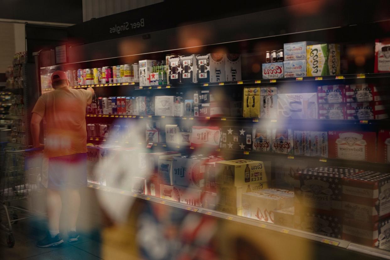 A man shops in the alcohol section at a grocery store in Albuquerque on June 26, 2022.