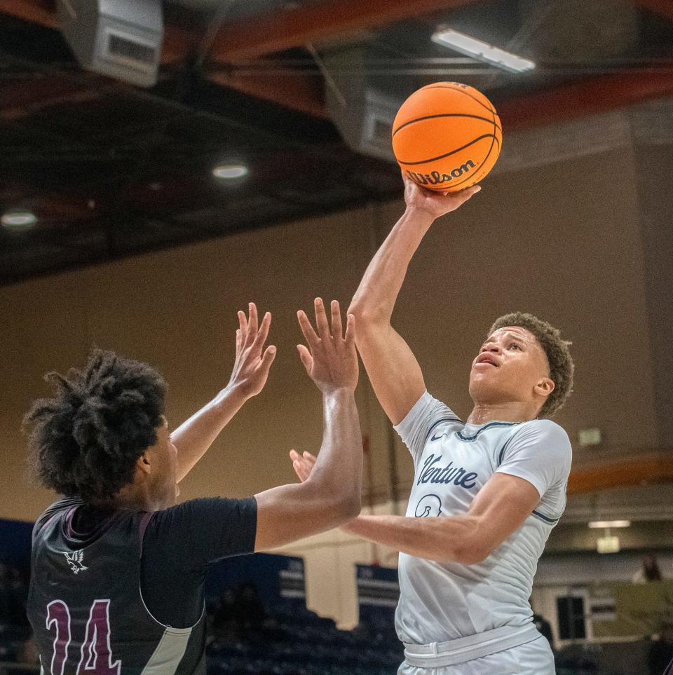 Venture Academy's Mario Williams, right, shoots over Natomas' Achilles Terrell during the Sac-Joaquin Section Div. 4 boys basketball championship game at U.C. Davis' University Credit Union Center in Davis on Feb. 23, 2024. Venture Academy won 78-74.