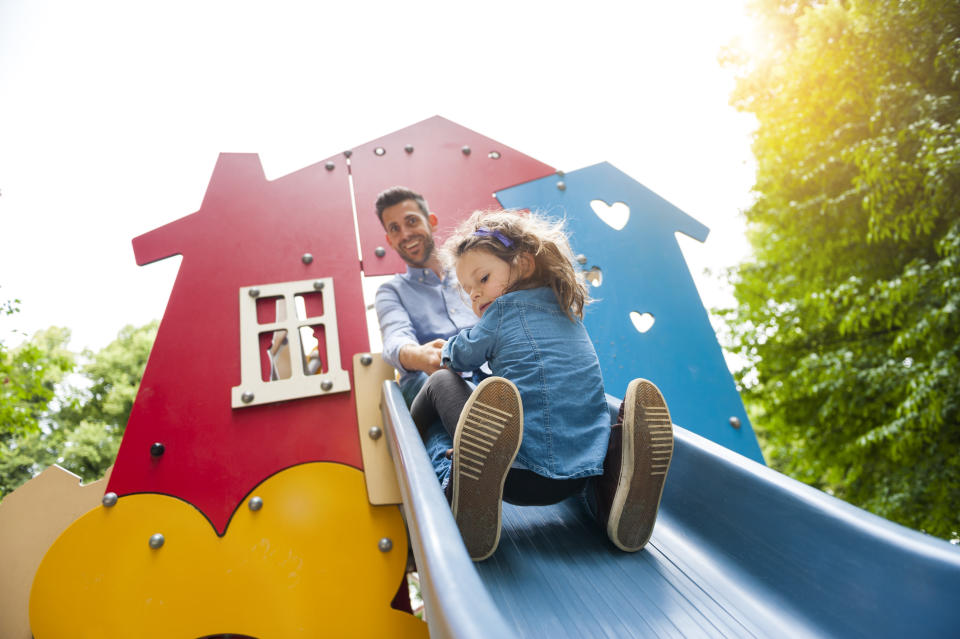 Dad on a slide with child