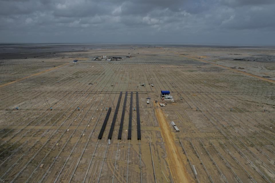 Solar panels are installed at an under-construction site of Adani Green Energy Limited's Renewable Energy Park in the salt desert of Karim Shahi village, near Khavda, Bhuj district near the India-Pakistan border in the western state of Gujarat, India, Thursday, Sept. 21, 2023. When completed, the project will be about as large as Singapore. (AP Photo/Rafiq Maqbool)