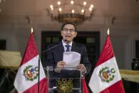 In this photo provided by the Peruvian presidential press office, Peru's President Martin Vizcarra delivers a national message from the government palace in Lima, Peru, Monday, Sept. 30, 2019. Vizcarra announced he had dissolved his nation’s opposition-controlled congress amid a bitter feud over his fight to curb corruption. (Andres Valle/Peruvian presidential press office, via AP)