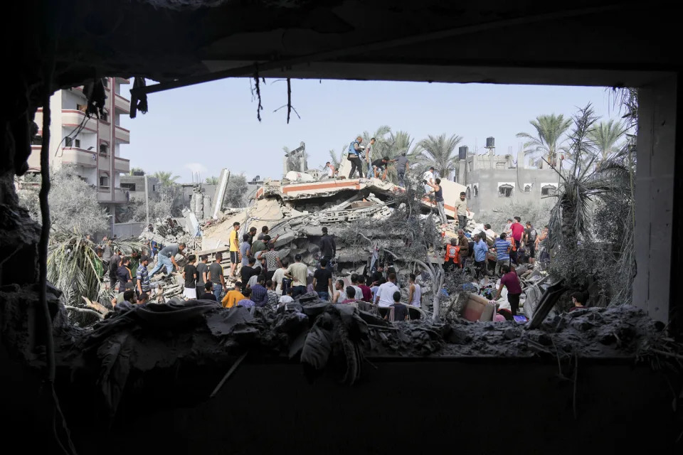 Palestinians look for survivors after the Israeli bombardment in Deir Al-Balah, Gaza. (Hatem Moussa / AP)