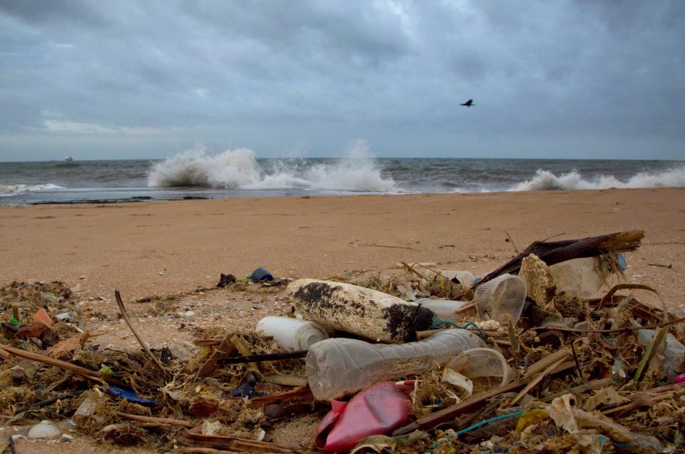 In a file photo, debris is seen washed ashore on a beach in Sri Lanka. According to a report from the United Nations released on March 13, 2019, climate change, a global major extinction of animals and plants, degraded land, polluted air, and plastics, pesticides and hormone-changing chemicals in the water are making the planet an increasing unhealthy place for people.