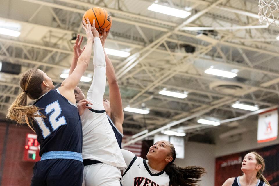 Salem Hills Skyhawks’ Sage Carrick (12), West Panthers guard/forward Kaydence Falatea (4) and West Panthers forward/center Jerzy Tapusoa (12) jump for the rebound during a game at West High School in Salt Lake City on Thursday, Feb. 22, 2024. | Marielle Scott, Deseret News