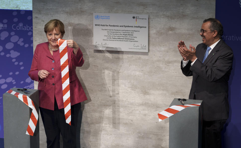 Tedros Adhanom Ghebreyesus, right, Director-General of the World Health Organization (WHO), and German Chancellor Angela Merkel, left, attend the inauguration ceremony of the 'WHO Hub For Pandemic And Epidemic Intelligence' at the Langenbeck-Virchow building in Berlin, Germany, Wednesday, Sept. 1, 2021. (AP Photo/Michael Sohn, pool)