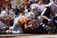 Texas quarterback Casey Thompson (11) lunges into the end zone for a touchdown against Texas Tech during the first half of an NCAA college football game on Saturday, Sept. 25, 2021, in Austin, Texas. (AP Photo/Chuck Burton)