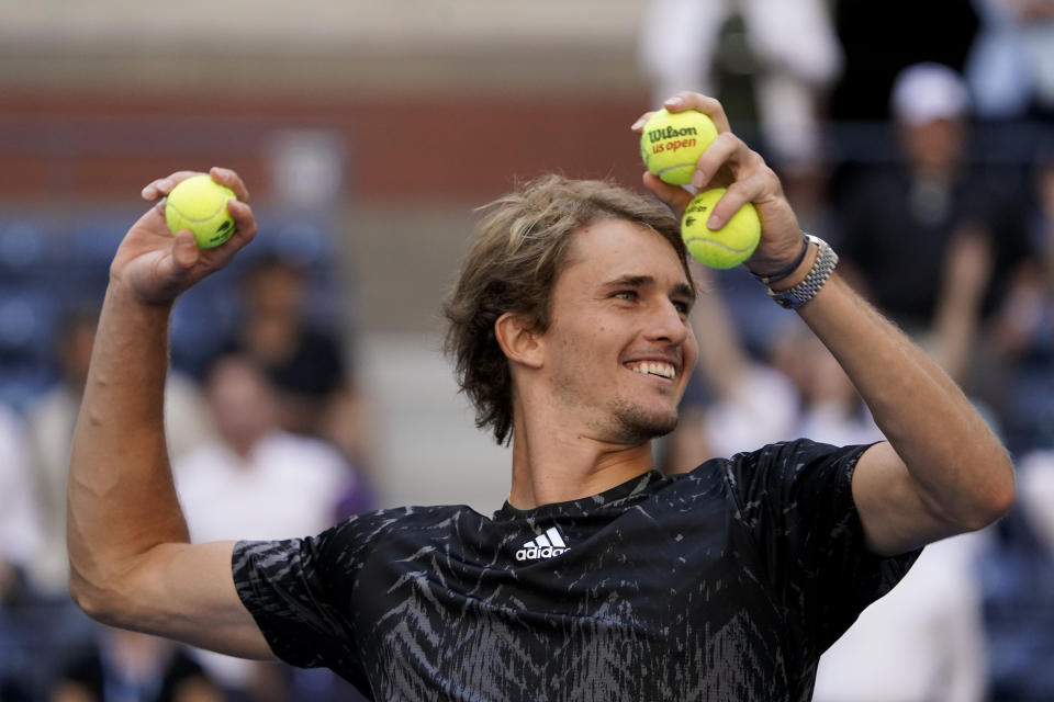 Alexander Zverev, of Germany, throws balls to tennis fans after defeating Albert Ramos-Vinolas, of Spain, during the second round of the US Open tennis championships, Thursday, Sept. 2, 2021, in New York. (AP Photo/Elise Amendola)