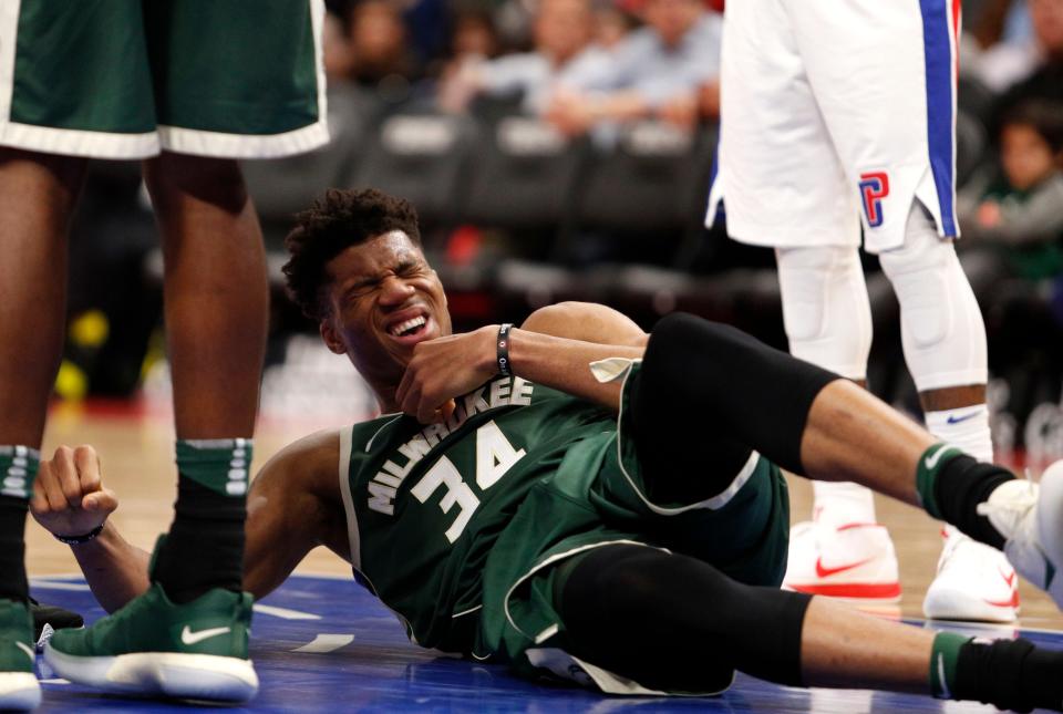 Milwaukee Bucks forward Giannis Antetokounmpo goes down with an injury during the fourth quarter against the Detroit Pistons Feb. 28, 2018, at Little Caesars Arena.