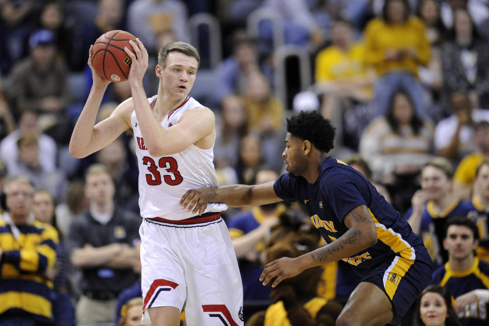 Nick Muszynski holds the ball away from a defender.