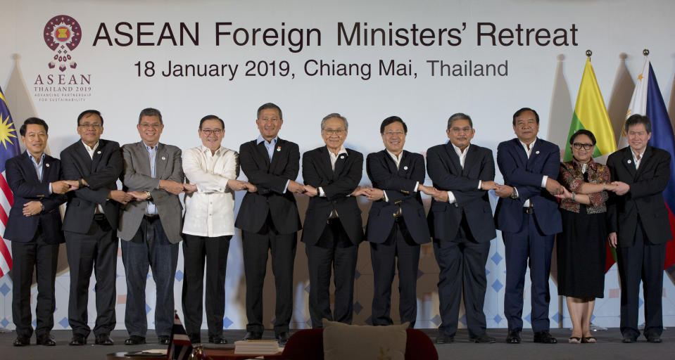 Foreign ministers of the Association of Southeast Asian Nations (ASEAN) join hands for a group photo during the ASEAN Foreign Ministers' retreat in Chiang Mai, Thailand, Friday, Jan. 18, 2019. They are from left to right, Laos' Saleumxay Kommasith, Myanmar's Kyaw Tin, Malaysia's Saifuddin Abdullah, Philippines Foreign Affaires Secretary Teodoro Locsin Jr., Singapore's Vivian Balakrishnan, Thailand's Don Pramudwinai, Vietnam's Phạm Binh Minh, Brunei Second Minister of Foreign Affaires and Trade Erywan Yusof, Cambodia's Prak Sokhon, Indonesia's Retno Marsudi and ASEAN Secretary-General Dato Lim Jock Hoi. (AP Photo/Gemunu Amarasinghe)