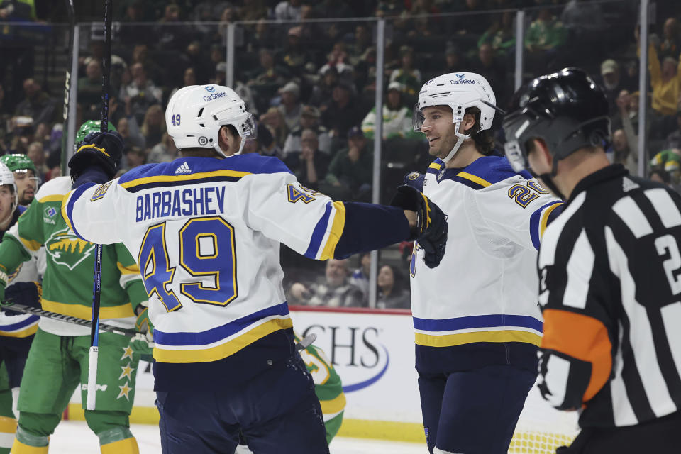 St. Louis Blues left wing Brandon Saad (20) celebrates with center Ivan Barbashev (49) after scoring a goal against the Minnesota Wild during the first period of an NHL hockey game Sunday, Jan. 8, 2023, in St. Paul, Minn. (AP Photo/Stacy Bengs)