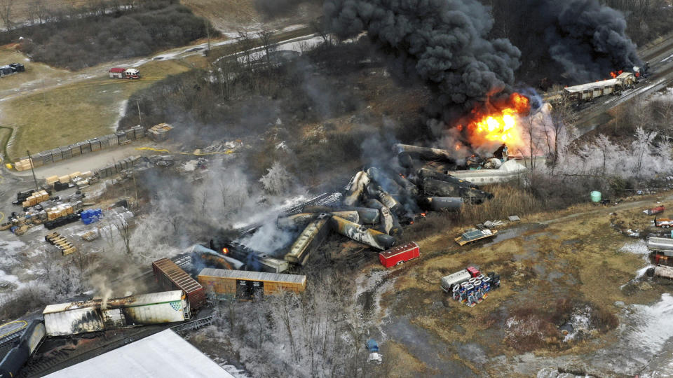 FILE - In this photo taken with a drone, portions of a Norfolk Southern freight train that derailed the previous night in East Palestine, Ohio, remain on fire at mid-day on Feb. 4, 2023. Lawyers and unions who represent rail workers say there is a clear pattern across the industry of railroads retaliating against workers who report safety violations or injuries on the job. (AP Photo/Gene J. Puskar, File)