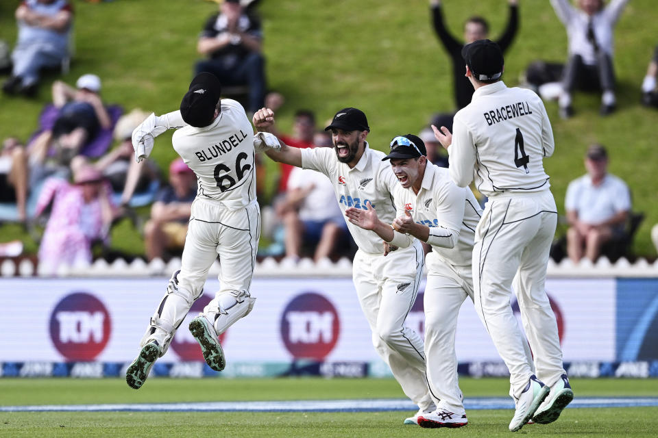 New Zealand's Tom Blundell, left, celebrates with teammates after catching out England's Ben Duckett on day 5 of their cricket test match in Wellington, New Zealand, Tuesday, Feb 28, 2023. (Andrew Cornaga/Photosport via AP)