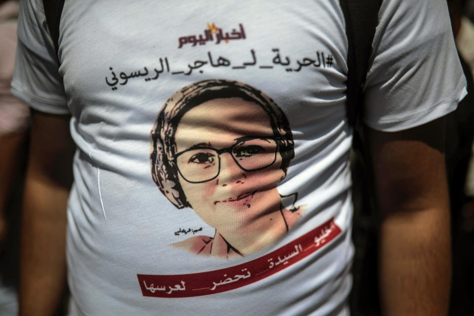 A journalist attends a demonstration outside a court in solidarity with detained journalist Hajar Raissouni, in Rabat, Morocco, Monday, Sept. 9, 2019. Words in Arabic read "Free Hajar". (AP Photo/Mosa'ab Elshamy)