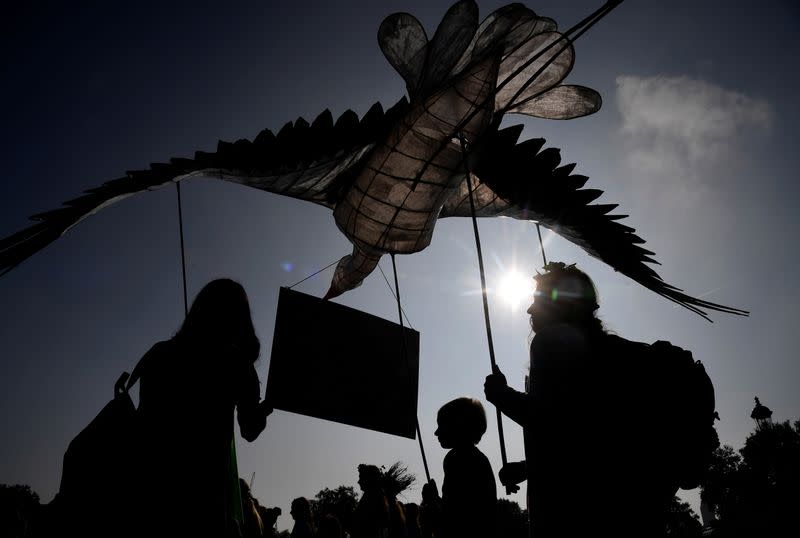 FILE PHOTO: Environmental campaigners march ahead of the COP26 climate summit, in London