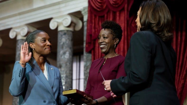 Vice President Kamala Harris (right) swears in Laphonza Butler (left) to the Senate to succeed the late Democratic Sen. Dianne Feinstein during a re-enactment of the swearing-in ceremony on Tuesday, Oct. 3, 2023, on Capitol Hill in Washington. Butler’s wife, Neneki Lee (center), holds the Bible. (Photo: Stephanie Scarbrough/AP)