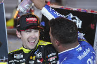 Bubba Wallace, right, pours a drink on Ryan Blaney in Victory Lane after Blaney won the NASCAR All-Star auto race at Texas Motor Speedway in Fort Worth, Texas, Sunday, May 22, 2022. (AP Photo/LM Otero)