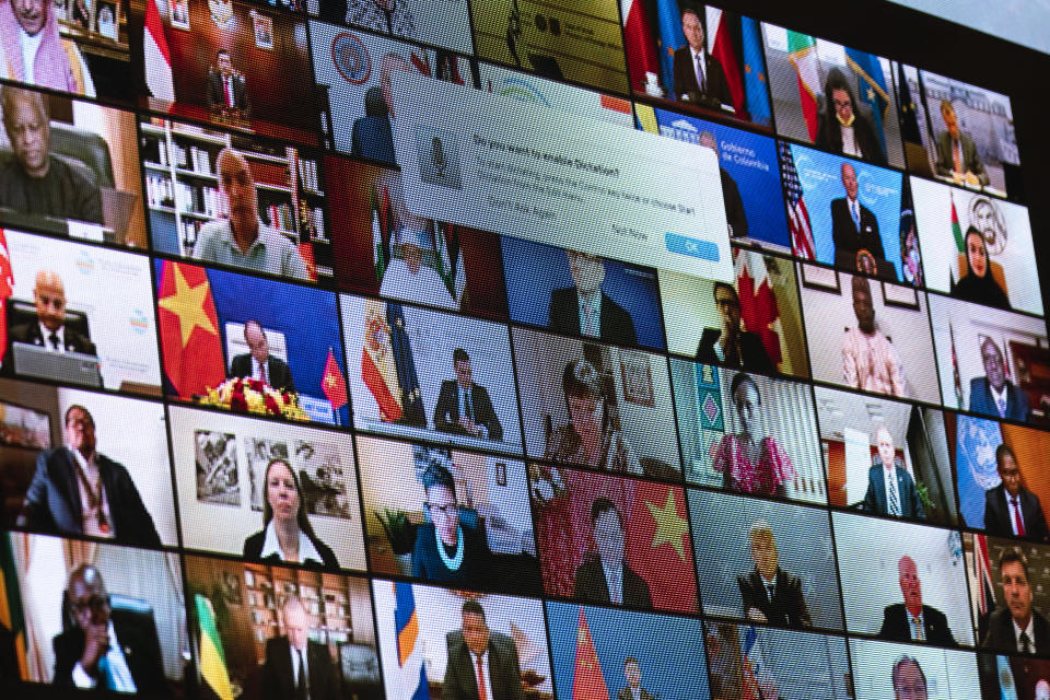 World leaders are shown on a screen as President Joe Biden speaks to the virtual Leaders Summit on Climate, from the East Room of the White House, Friday, April 23, 2021, in Washington. (AP Photo/Evan Vucci)