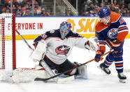 Columbus Blue Jackets goalie Elvis Merzlikins (90) stops Edmonton Oilers' Zach Hyman (18) during the second period of an NHL hockey game in Edmonton, Alberta, Tuesday, Jan. 23, 2024. (Amber Bracken/The Canadian Press via AP)