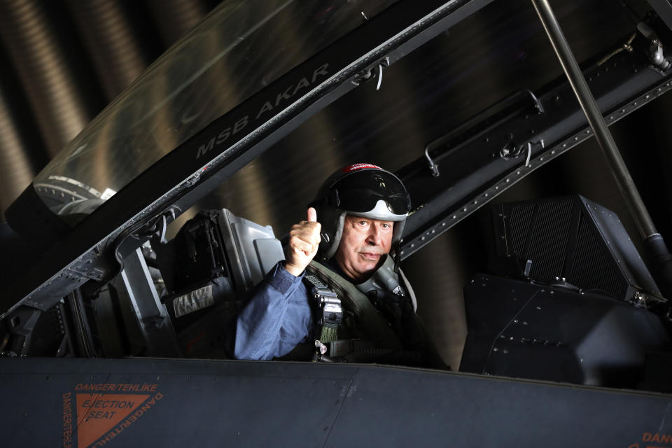 Turkey's Defense Minister Hulusi Akar gives a tumb-up while sitting inside an F-16 jet fighter at a military air base in western city of Eskisehir, Turkey, Wednesday, Sep. 2, 2020, before a training flight over Turkish Monument in Gallipoli peninsula. Akar said Thursday that Washington's lifting the arms embargo against Greek Cypriot-administered Cyprus will lead to a deadlock. "If you lift the embargo and try to disrupt the balance in this way, this will bring conflict, not peace," he said.(Turkish Defense Ministry via AP, Pool)