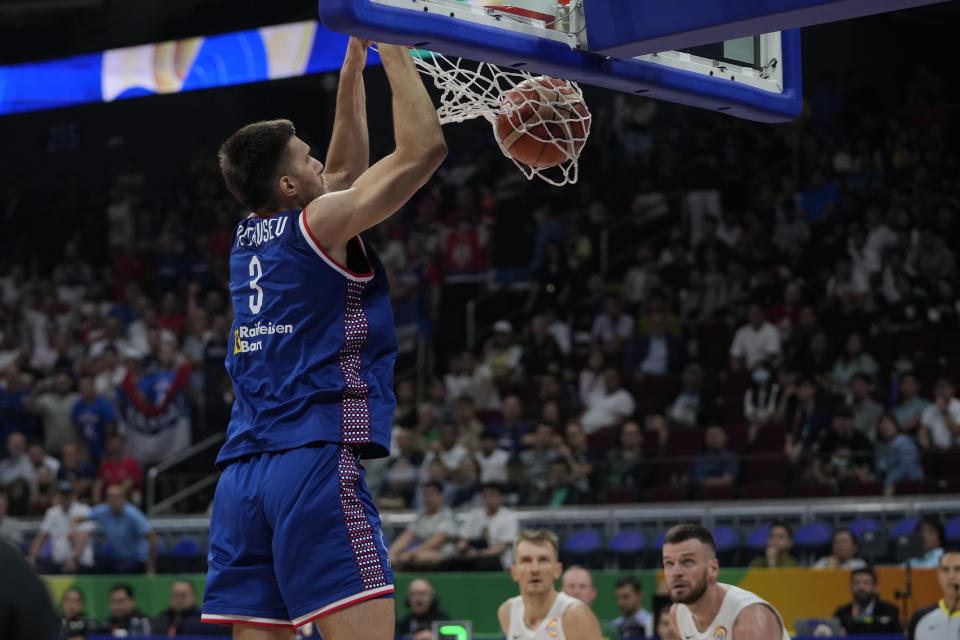 Serbia center Filip Petrusev (3) dunks the ball during the Basketball World Cup quarterfinal game between Lithuania and Serbia at the Mall of Asia Arena in Manila, Philippines, Tuesday, Sept. 5, 2023. (AP Photo/Aaron Favila)