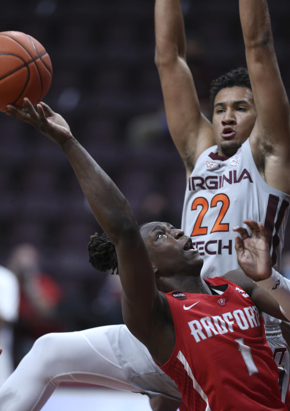 Radford's Keishon Porter (1) attempts to shoot past Virginia Tech's Keve Aluma (22) during the second half of an NCAA college basketball game, Wednesday Nov. 25, 2020, in Blacksburg Va. (Matt Gentry/The Roanoke Times via AP)