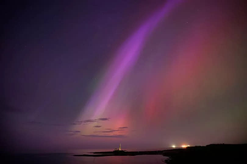 The aurora borealis, also known as the northern lights, glow in the sky over St Mary's Lighthouse in Whitley Bay -Credit:Owen Humphreys/PA Wire