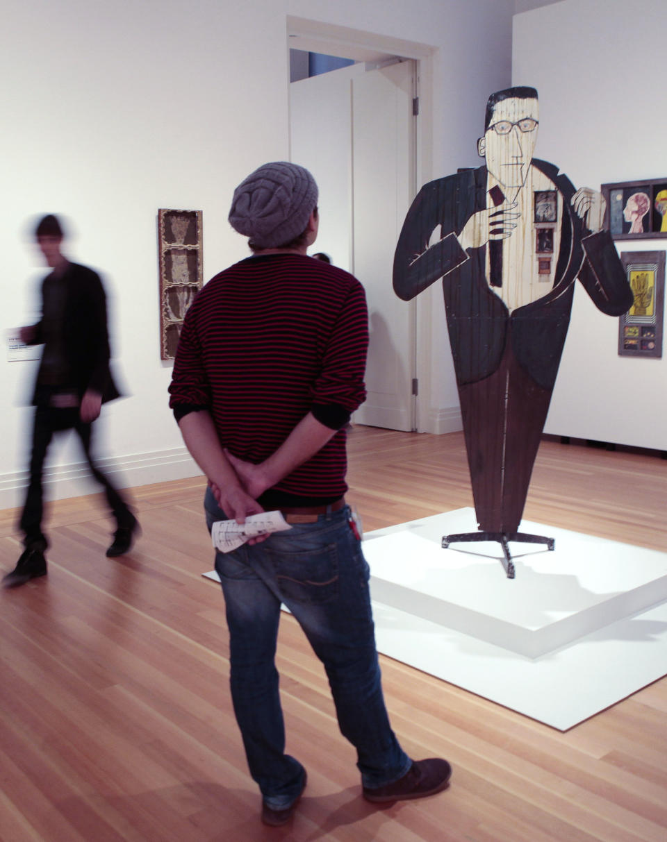 A man looks at the sculpture titled 'Walter Hopps Hopps Hopps' created in 1959 by Edward Kienholz during a press preview of the exhibition 'Pacific Standard Time' in Berlin, Wednesday, March 14, 2012. An exhibition that offers viewers a primer on three decades of Los Angeles' art scene and stems from a decade of research is opening in Berlin, Thursday, March 15. (AP Photo/Markus Schreiber)