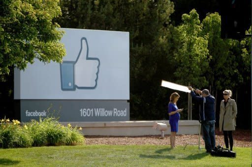 A television crew prepares for a broadcast in front of a 'like' sign outside Facebook headquarters in Menlo Park, California. Facebook stumbled in its first trading day Friday as shares ended barely above the starting price after a glitch-plagued market debut on the Nasdaq that failed to live up to the enormous hype