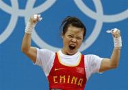 China's Mingjuan Wang celebrates her lift on the women 48Kg Group A weightlifting competition at the London 2012 Olympic Games July 28, 2012.