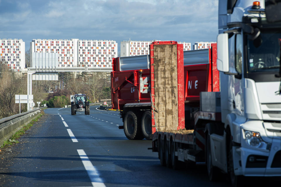 French farmers block the Hubert Touya viaduct on a highway Tuesday, Jan. 23, 2024 in Bayonne, southwestern France. Farmers have for months been protesting for better pay and against what they consider to be excessive regulation, mounting costs and other problems. (AP Photo/Nicolas Mollo)