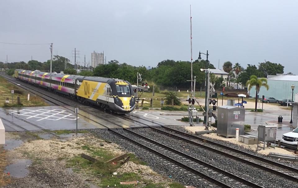 In this screen image from video, a Brightline train #116 that was stopped at Avenue A (southbound) with the crossing arms up, then started across the intersection before the crossing arms came down on Wednesday, Sept. 19, 2023, in Fort Pierce.