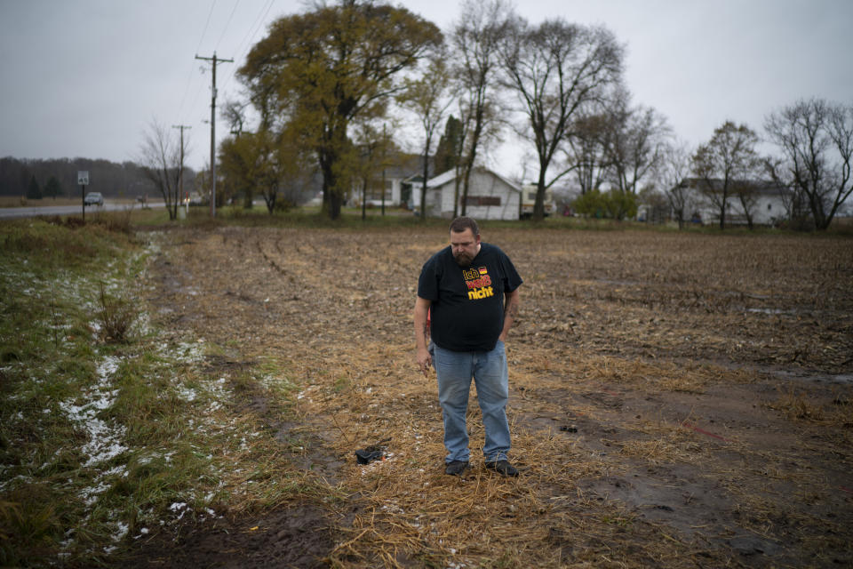 A relative of the adult victim struck and killed by a vehicle Saturday looks at the path he thought the truck took when it veered off Wisconsin County Hwy. P, Sunday, Nov. 4, 2018. The western Wisconsin community is grieving the deaths of three Girl Scouts and an adult who were collecting trash along a rural highway when police say a pickup truck veered off the road and hit them before speeding away. (Jeff Wheeler/Star Tribune via AP)