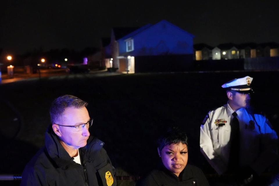 Columbus police assistant chief LaShanna Potts, foreground center, speaks with the media near the scene of a triple homicide Tuesday night on Kodiak Drive in the Winchester Lakes Apartments on the city's Southeast Side near Canal Winchester.