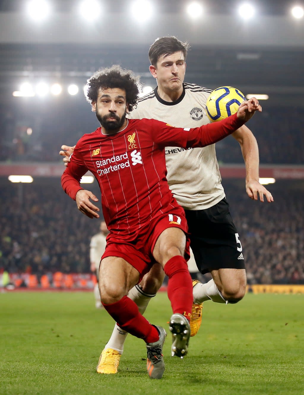 Liverpool’s Mohamed Salah (left) and Manchester United’s Harry Maguire battle for the ball (Martin Rickett/PA). (PA Archive)