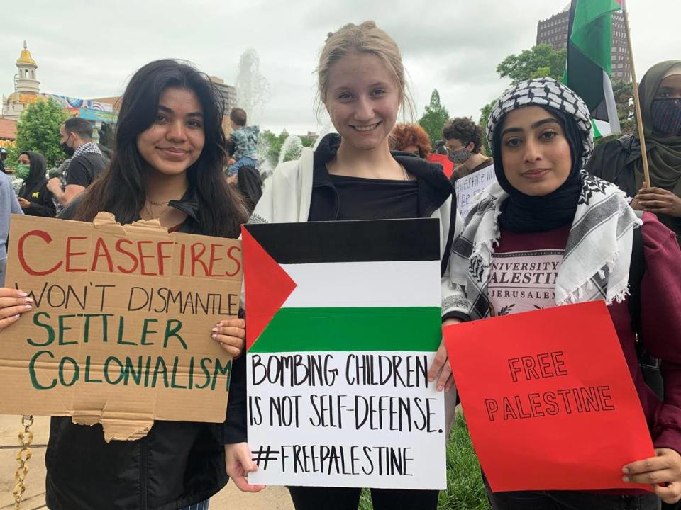 Amreen Hasan, 21, Kat Schneider, 20, and Amber Gillani, 19, from left to right, attended the protest on the Country Club Plaza in support of Palestinian people on Saturday, May 22.