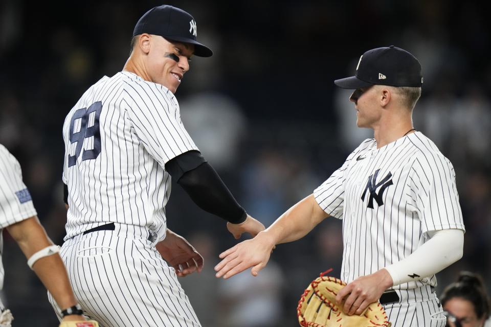 New York Yankees' Aaron Judge, left, celebrates with Jake Bauers after the team's baseball game against the Washington Nationals on Wednesday, Aug. 23, 2023, in New York. Judge had three home runs as the Yankees won 9-1. (AP Photo/Frank Franklin II)