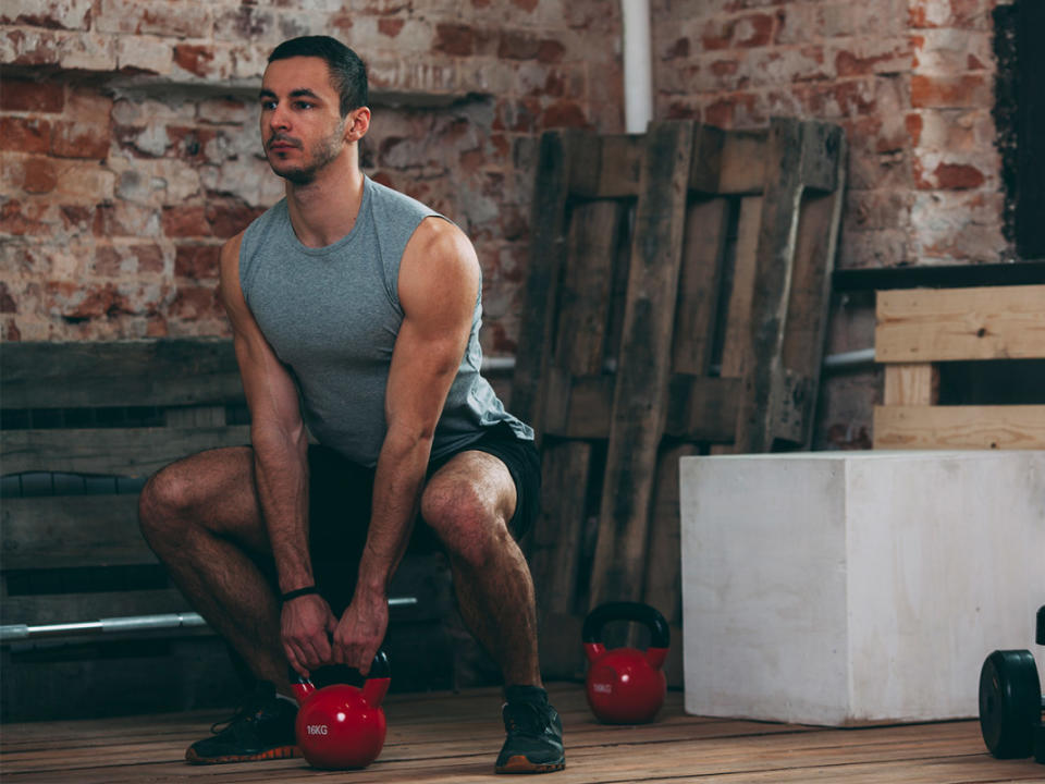 How to do it:<ol><li>Place a kettlebell directly beneath you, between your feet.</li><li>Position your legs hip-width apart with toes facing forward.</li><li>"If you need to go slightly wider than hip-width apart and/or point your toes slightly out to the sides, that’s alright," Ibrahim says.</li><li>"While keeping your core engaged to avoid arching at your lower back, drive your hips back into a hip hinge."</li><li>Grab each side of the kettlebell's handle.</li><li>Stand up tall, and squeeze your glutes at the top.</li><li>Slowly lower the kettlebell down to your shins, then repeat.</li></ol>