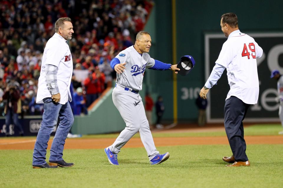 BOSTON, MA - OCTOBER 24:  Dave Roberts #30 of the Los Angeles Dodgers embraces former Red Sox players Tim Wakefield and Kevin Millar prior to Game Two of the 2018 World Series at Fenway Park on October 24, 2018 in Boston, Massachusetts.  (Photo by Maddie Meyer/Getty Images)