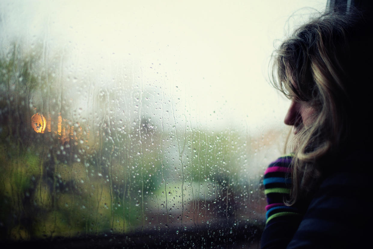 Woman looking at stormy weather. (Getty Images)