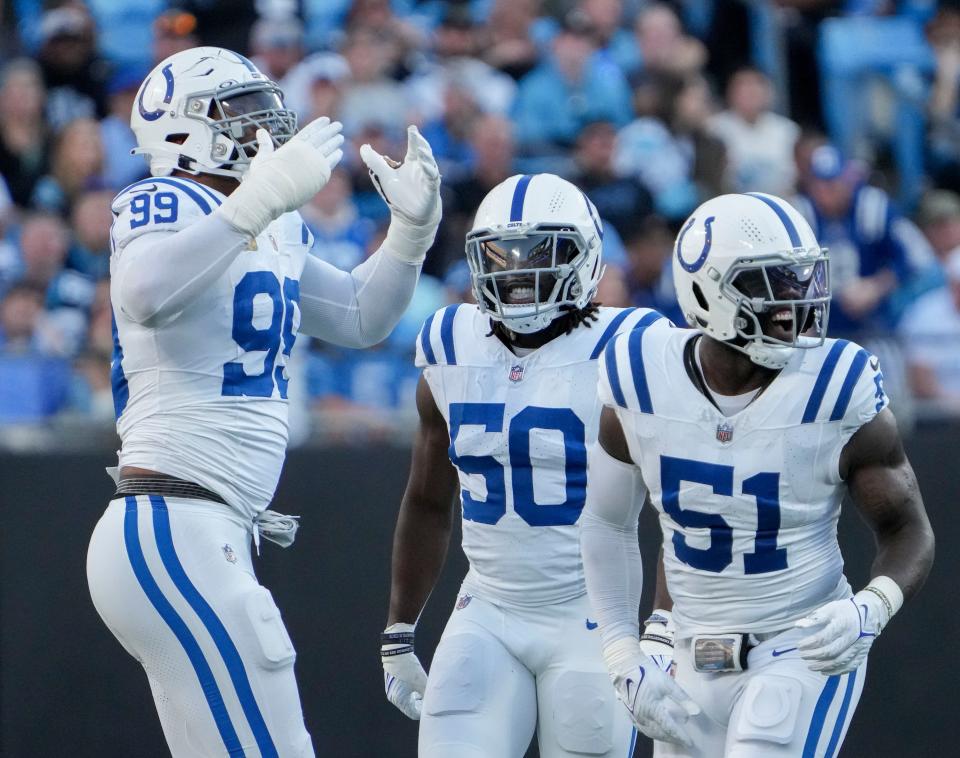 Indianapolis Colts defensive tackle DeForest Buckner (99) blows kisses to the crowd as linebacker Segun Olubi (50) and defensive end Kwity Paye (51) celebrate a sack last Sunday.