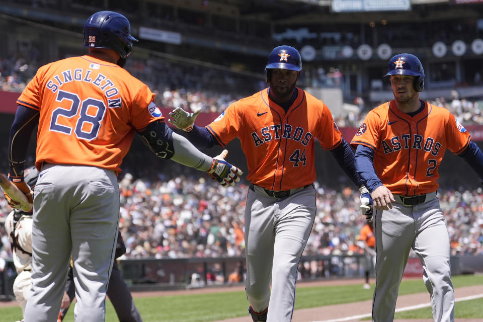 Houston Astros' Yordan Alvarez, middle, is congratulated by Jon Singleton (28) after hitting a two-run home run that also scored Alex Bregman, right, against the San Francisco Giants during the sixth inning of a baseball game in San Francisco, Wednesday, June 12, 2024. (AP Photo/Jeff Chiu)
