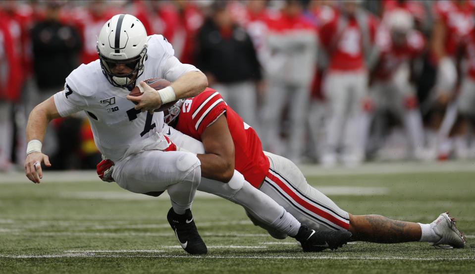 Ohio State linebacker Malik Harrison, right, tackles Penn State quarterback Will Levis during the second half of an NCAA college football game Saturday, Nov. 23, 2019, in Columbus, Ohio. Ohio State beat Penn State 28-17. (AP Photo/Jay LaPrete)