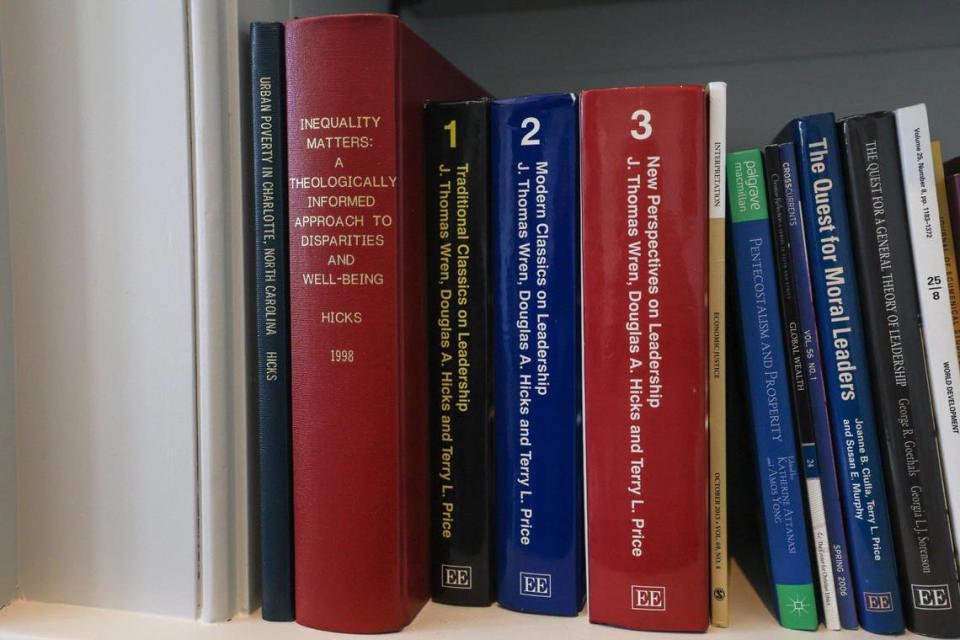 The thesis that Doug Hicks wrote at Davidson College on poverty in Charlotte sits on the far left of his office bookshelf.