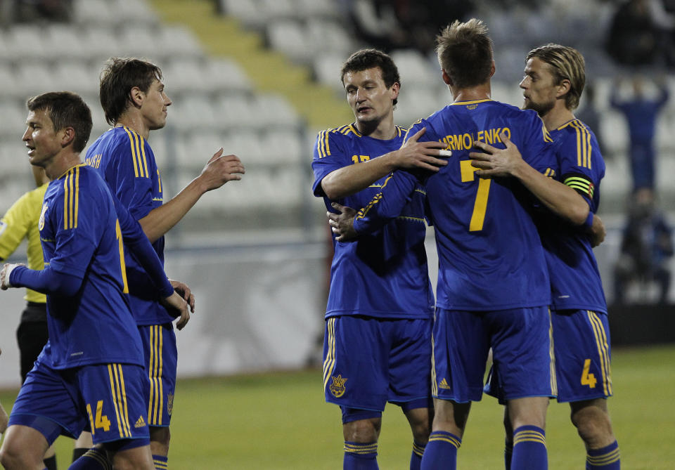 Andriy Yarmolenko, center right, of Ukraine celebrates his goal with his teammates against the U.S. during an international friendly match at Antonis Papadopoulos stadium in southern city of Larnaca, Cyprus, Wednesday, March 5, 2014. The Ukrainians are facing the United States in a friendly in Cyprus, a match moved from Kharkiv, Ukraine, to Larnaca for security reasons. (AP Photo/Petros Karadjias)