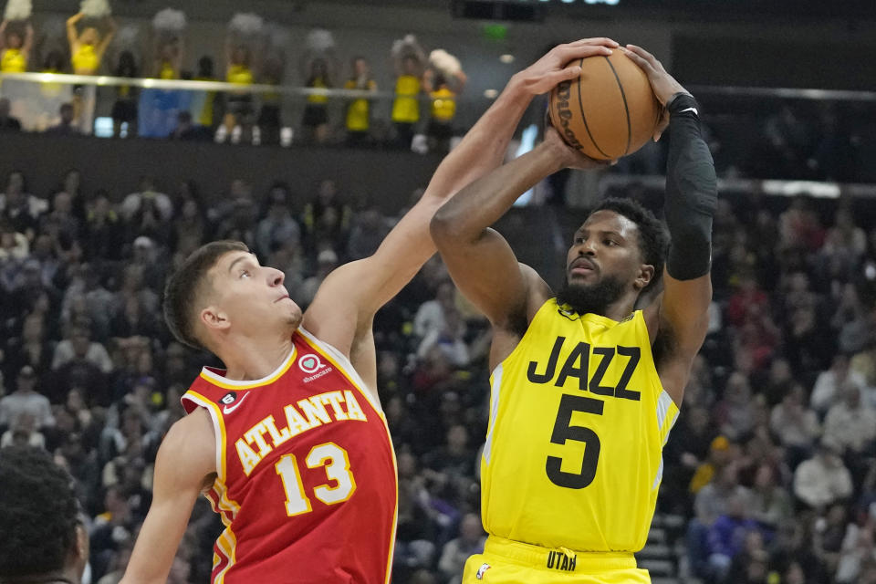 Atlanta Hawks guard Bogdan Bogdanovic (13) defends against Utah Jazz guard Malik Beasley (5) during the second half of an NBA basketball game Friday, Feb. 3, 2023, in Salt Lake City. (AP Photo/Rick Bowmer)