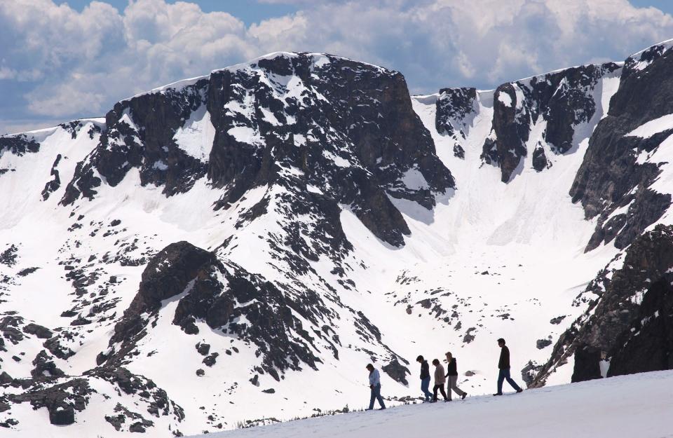 People walk near the Trail Ridge Road May 23, 2003, in Rocky Mountain National Park, Colorado.