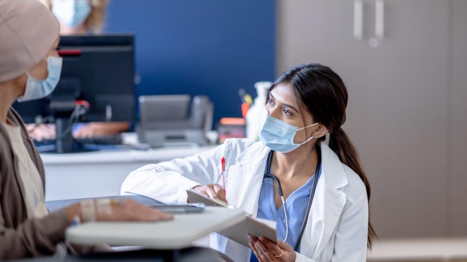 Una doctora atiende a una paciente con cáncer