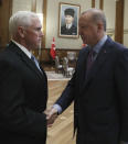 U. S. Vice President Mike Pence, left, and Turkish President Recep Tayyip Erdogan shake hands before their talks at the presidential palace, in Ankara, Turkey, Thursday, Oct. 17, 2019. A high level U.S. delegation arrived in Turkey on Thursday for talks on a cease-fire in Syria. (Presidential Press Service via AP, Pool )